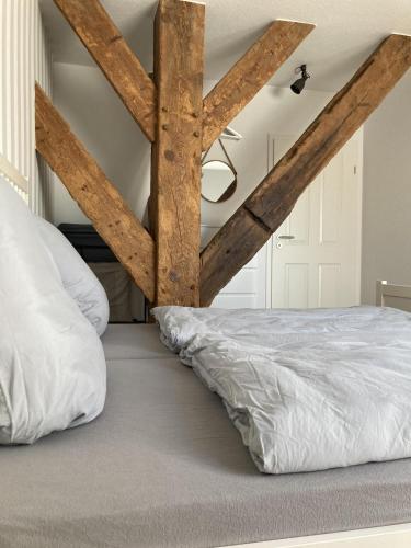 a bedroom with a bed with wooden beams at Bauernhof-Steffens in Tating