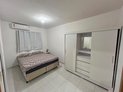 a small bedroom with a bed and a dresser at Przibilwiez Hause in João Pessoa