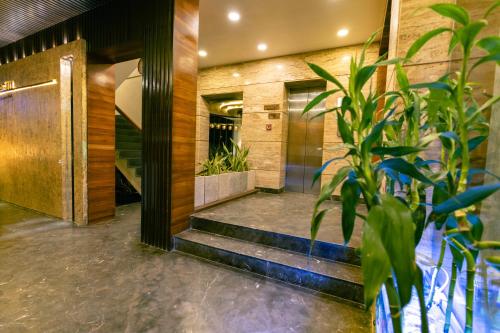 a lobby with stairs and a plant at Hotel Seagull in Digha