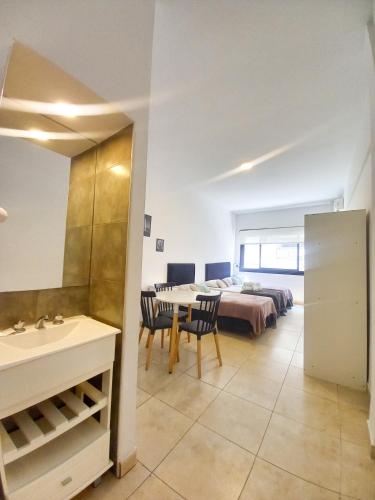 a room with a bed and a table and chairs at Osiris Plaza in Buenos Aires