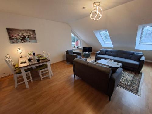 a living room with a couch and a table at Ferienwohnung Roessing 25194 in Bunde