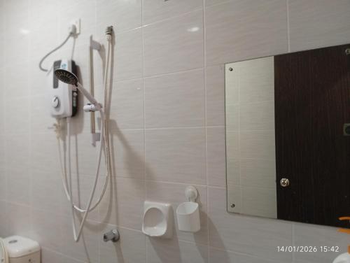 a bathroom with a shower with a sink and a mirror at Seberang Jaya Family Pool Homestay Near Hospital 3 Bedroom Aircond 2 Bathroom & Family Room Aircond in Perai