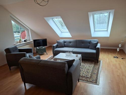 a living room with a couch and a table at Ferienwohnung Roessing 25194 in Bunde