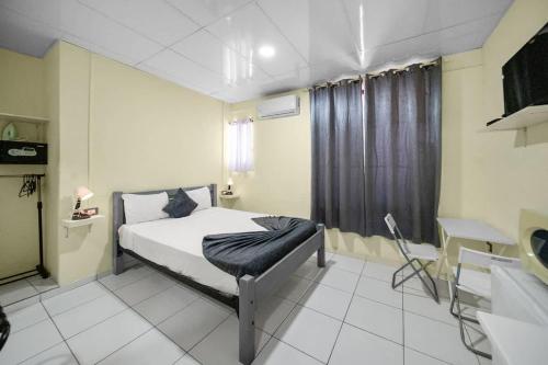 a bedroom with a bed and a sink in it at Cheap Hotel Room in Sosua Center in Sosúa