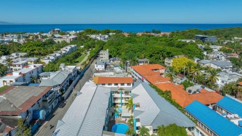 an aerial view of a city with houses and the ocean at Cheap Hotel Room in Sosua Center in Sosúa