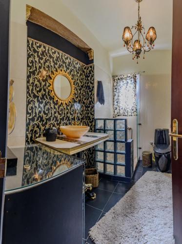 a bathroom with a sink and a mirror on a wall at Aerino House in Dassia