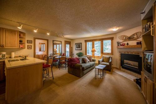 a kitchen and living room with a couch and a fireplace at Iron Horse Building D Unit 4104 in Winter Park