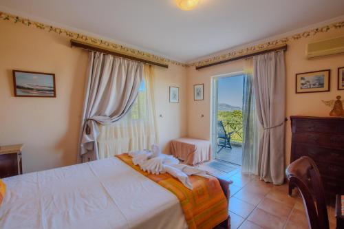 a bedroom with a large bed and a balcony at Aerino House in Dassia