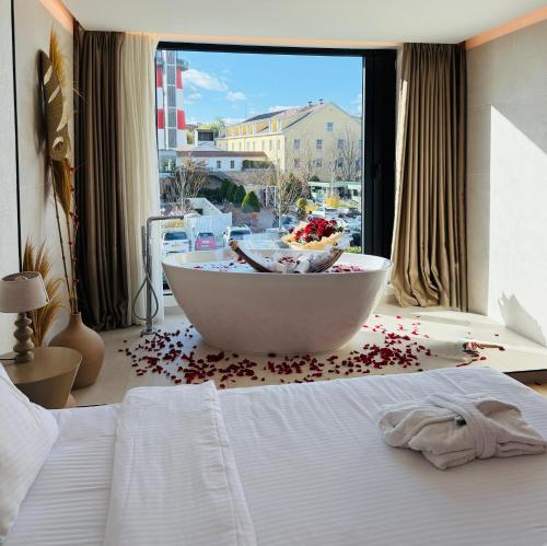 a bedroom with a large bed with a bowl on the floor at Hayat Hotels & Apartments in Rust