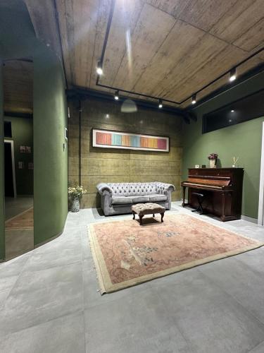 a living room with a couch and a piano at The Underground MOOTEL in Porumbacu de Jos