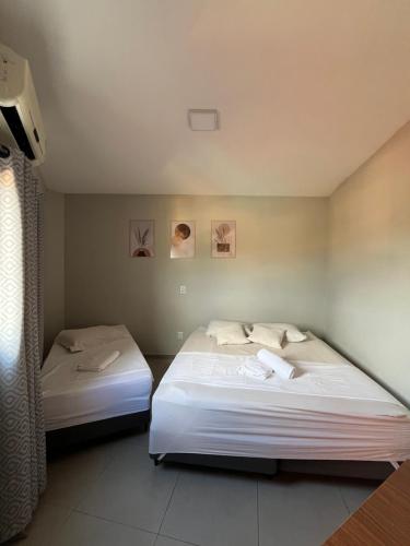 a bedroom with two beds in a room at Casa Lua in Brumadinho