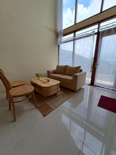 a living room with a couch and a coffee table at Carika Cabin in Diyeng