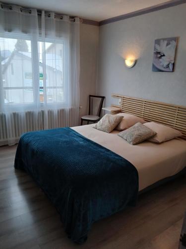 a bedroom with a large bed and a window at Chez Les Papa's in Aspres-sur-Buëch