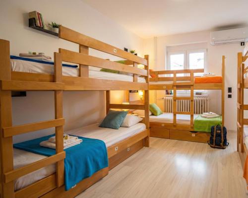 a room with three bunk beds in a house at BGD Downtown Hostel in Belgrade