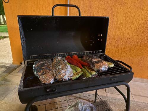 a grill with some meat and vegetables on it at Villa Clementinka - 200 meters from the sea in Khlorakas