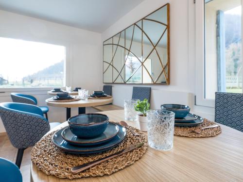 a dining room with a table with blue bowls and chairs at Lambo Cellini - Bed & Breakfast in Valdobbiadene