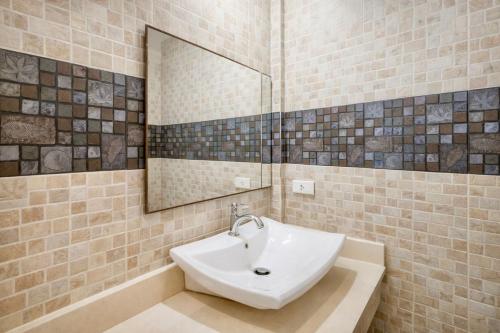 a bathroom with a sink and a mirror at Samui Pier Beach Front & Resort in Bangrak Beach