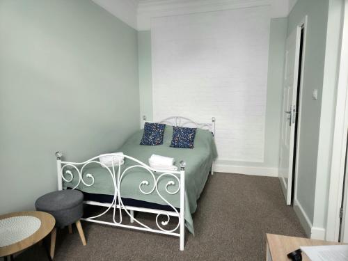 a bedroom with a bed with blue pillows at Apartamenty u Antka in Nowe Miasto Lubawskie