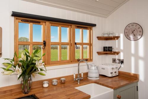 a kitchen with a sink and a window at Ockeridge Rural Retreats in Worcester