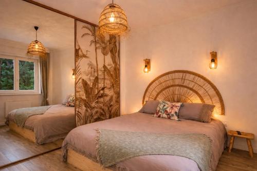 a bedroom with two beds and a large mirror at - Chalet Cosy - Pleine nature in Lagnieu
