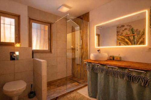 a bathroom with a shower and a sink and a toilet at - Chalet Cosy - Pleine nature in Lagnieu