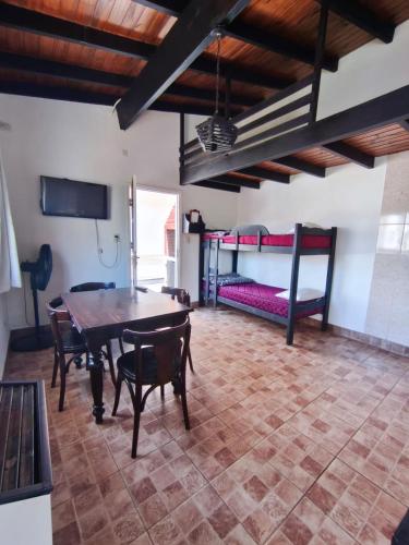 a living room with a table and a bunk bed at Bruna de Mar in Mar de Ajó