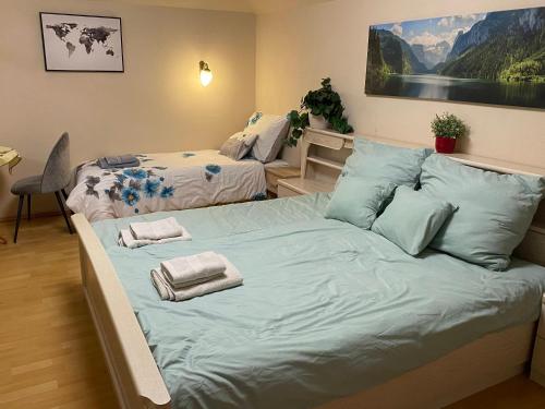 a bedroom with two beds with towels on them at Exigens House in Budapest