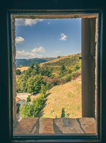 an open window with a view of a hill at Georgio's V Chalet Kalavrita in Kalavrita