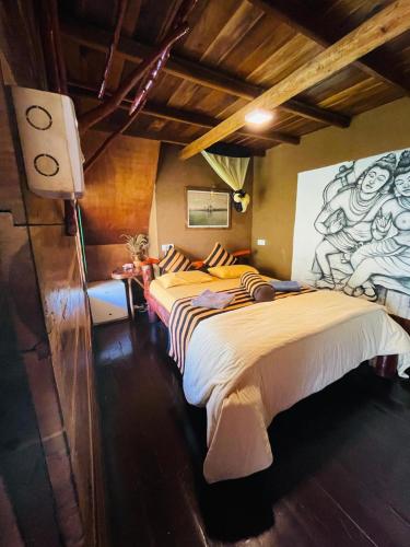 a bedroom with two beds and a painting on the wall at Mount Wood Ella in Ella