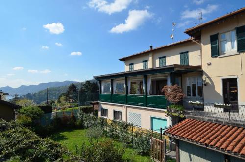 a view of a building with a green balcony at Albergo Della Torre in Cernobbio
