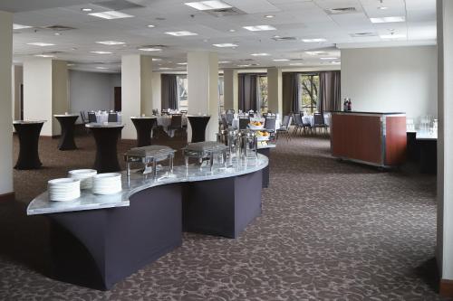 a restaurant with tables and chairs in a room at Courtyard Grand Rapids Downtown in Grand Rapids