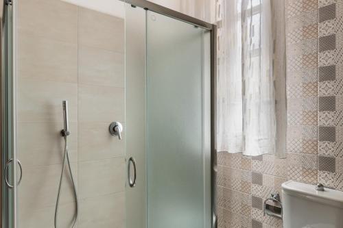 a shower with a glass door in a bathroom at Paco House in Avola