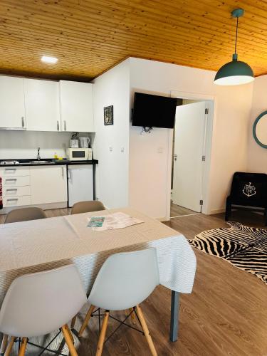 a kitchen and dining room with a table and chairs at Golden Halcyon - Ericeira Villas in Ericeira