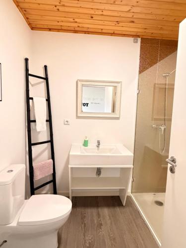 a bathroom with a sink and a toilet and a shower at Golden Halcyon - Ericeira Villas in Ericeira
