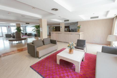 a lobby with couches and chairs and a table at Port Azafata Valencia in Manises