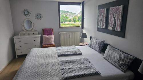 a bedroom with a bed and a mirror and a dresser at Ferienwohnungen Bongarden in Bernkastel-Kues