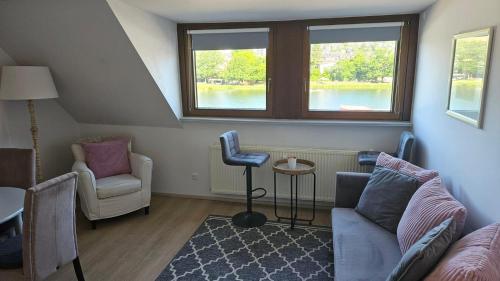 a living room with a couch and two chairs at Ferienwohnungen Bongarden in Bernkastel-Kues