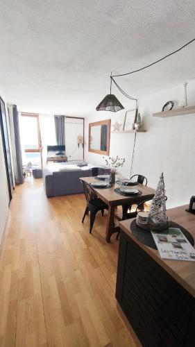 a living room with a couch and a table at Charmant Appartement Les temples du Soleil in Font-Romeu-Odeillo-Via