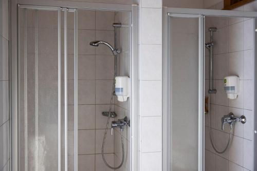 a bathroom with a shower with a glass door at Hecherhaus in Schwaz