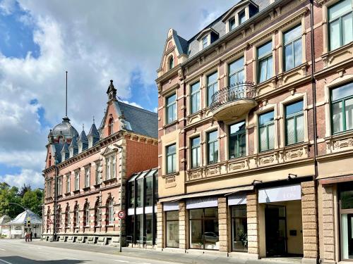 a large brick building with a statue on top of it at MAKERS and ROOMS APARTMENT 01 Pauline 110qm Parkplatz 1-4 Personen in Detmold