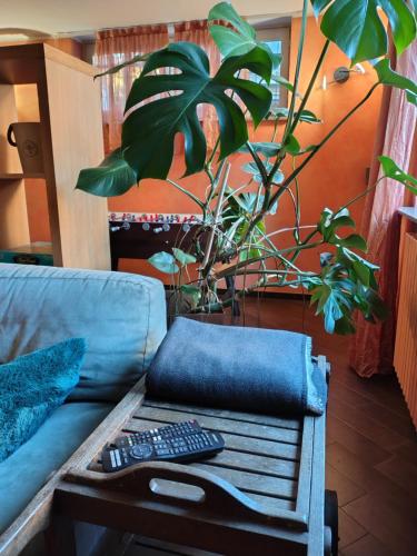a couch with two remote controls on a table at Appartamento Sleep&Fly in Grassobbio
