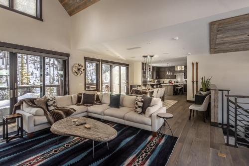 a living room with a couch and a table at Spanish Peaks - Highlands Cabin 36 in Big Sky