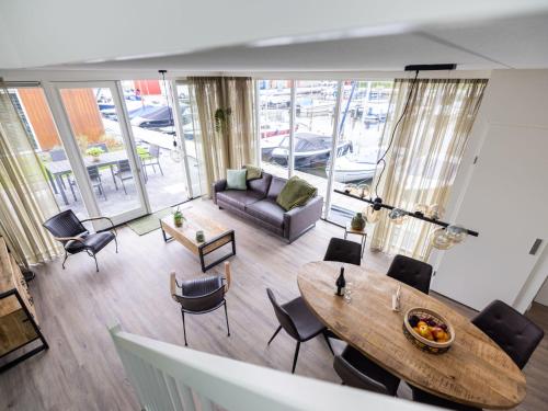 an overhead view of a living room with a table and chairs at Holiday Home De Meerparel by Interhome in Uitgeest