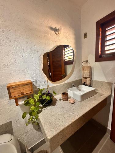a bathroom with a sink and a mirror at casa nova in Cruz