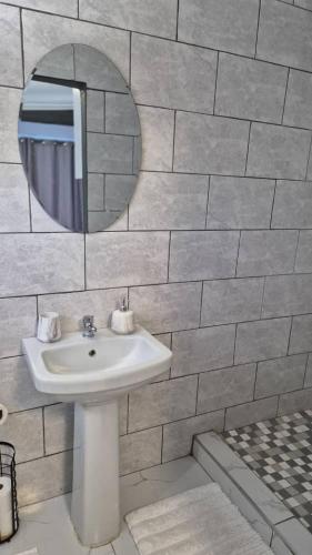 a bathroom with a sink and a mirror at KeAnna STAYS units in Tsumeb