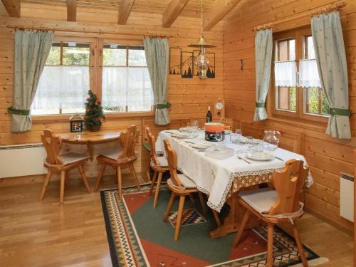a dining room with a table and chairs at Chalet Kil-Ukru by Interhome in Ovronnaz