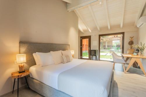 a bedroom with a large white bed and a table at Villa Il Platano in Como