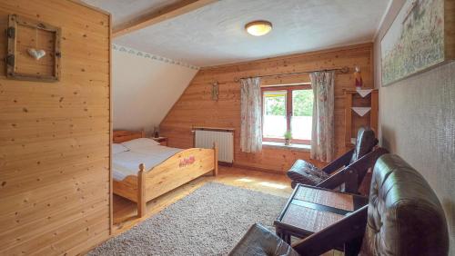 a small bedroom with a bed and a window at Eskapada in Stronie Śląskie
