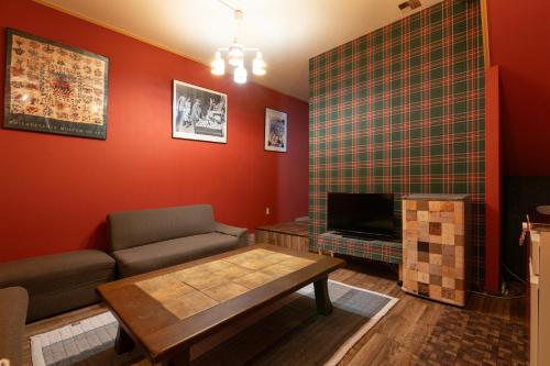 a living room with a couch and a table at Private house YOURSとなり in Osaka