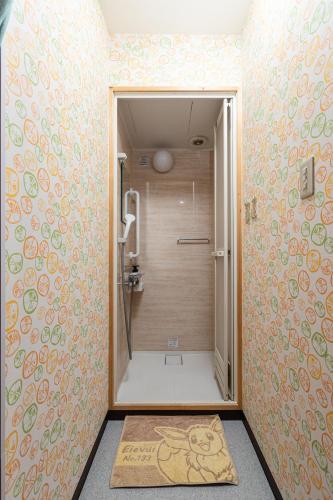 a bathroom with a shower with a toilet in it at Private house YOURSとなり in Osaka